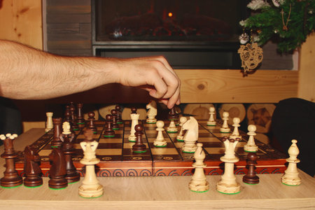 Wooden chess on the background of the fireplace, which is played on New Years Eve