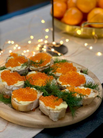 Festive candlelight dinner with shrimp and caviar sandwichesの写真素材