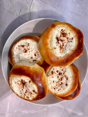 Pies with cheese are baked and ruddy on a gray plate