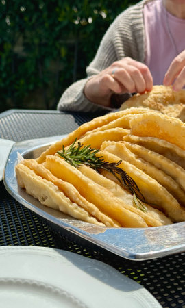At the picnic, delicious hot chebureks with meat are prepared for tastingの写真素材