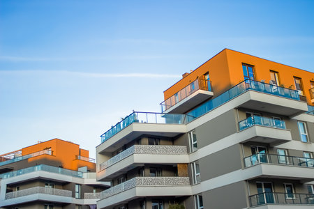 Multi-story gray buildings with wide continuous balconies and orange roofs have been built in the city. High quality photoの写真素材