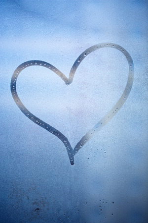 heart drawn on a wet windowの写真素材