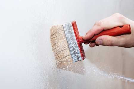 Priming of the wall with a brushの写真素材