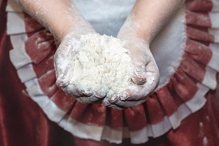 Close up of children hands holding wholemeal flour