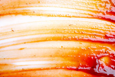 Smeared barbecue sauce or ketchup isolated on white background, close up. Flat lay, top view. Free copy space for text.の写真素材