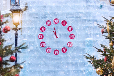 New Year clock on the ice wall. Christmas decoration.の写真素材