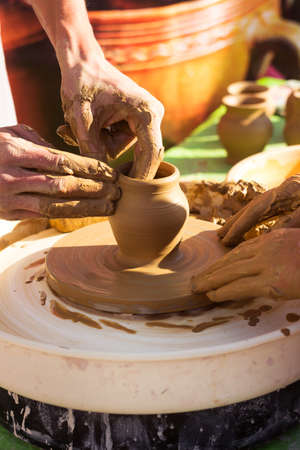 Master class in making a jug from clay, an adult teacher teaches a child to make clay productsの写真素材