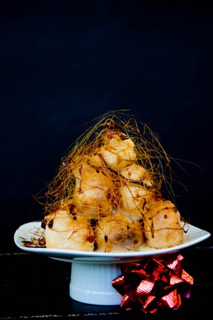 Profiterole, cream puff - French dessert choux pastry ball filled with whipped creamの写真素材