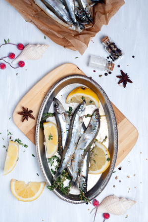 fresh fish with spices on wooden table, preparationの写真素材