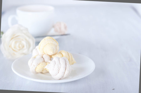 Homemade zefir marshmallows and cup of red teaの写真素材