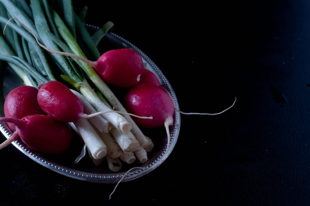 Delicious Fresh radishes from the garden on black backgroundの写真素材