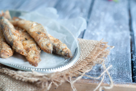 fried fish capelin on frypan isolated on white backgroundの写真素材