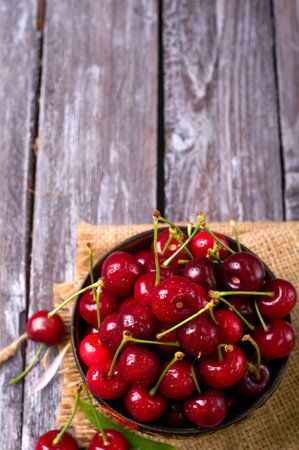 delicious fresh cherries on grey wooden table