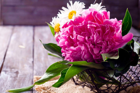 flowers pink peony on old wooden backgroundの写真素材