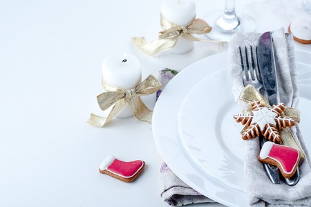 Christmas place setting with christmas cookies and candlesの写真素材