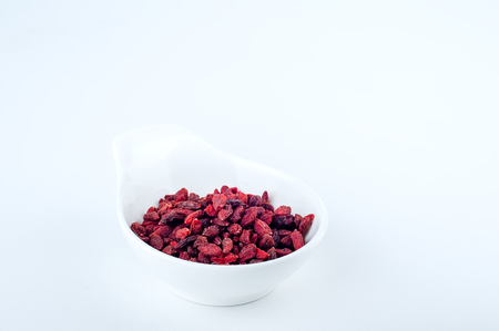 goji berries in a deep white plate on a white backgroundの写真素材