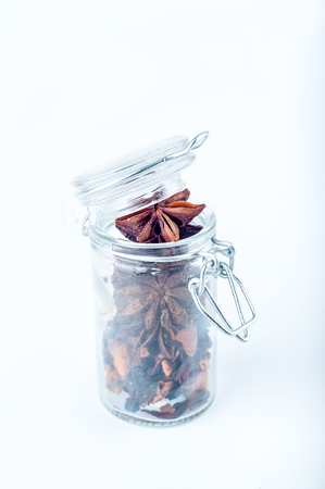 Star anise in the overturned glass jarの写真素材