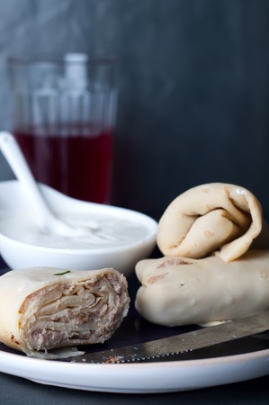 Stuffed pancakes crepes with meat and sauceの写真素材