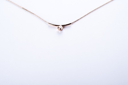 gold necklace with a stone isolated on white backgroundの写真素材