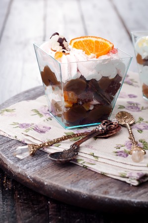 orange dessert  with cream in glass on darkの写真素材