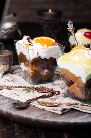 orange dessert  with cream in glass on darkの写真素材