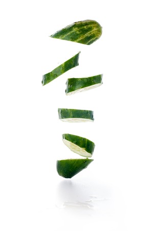 Cucumber and slices isolated over white backgroundの写真素材