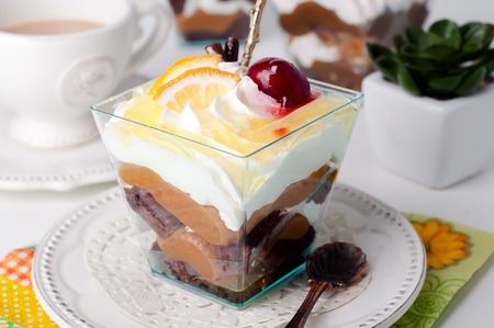 Sweet dessert in glass with biscuit,berry fruit and whipped creamの写真素材