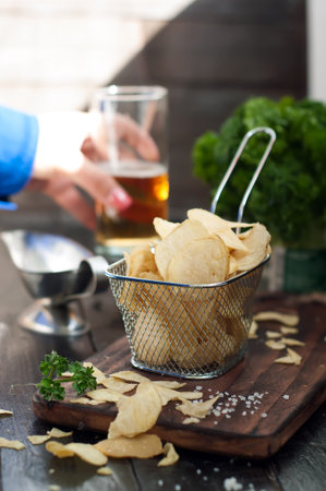 Crispy potato chips  on wooden background, top viewの写真素材