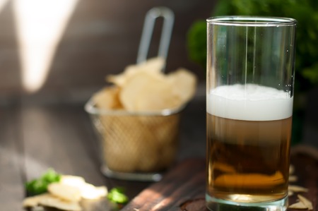 Mug of cold beer on wooden backgroundの写真素材