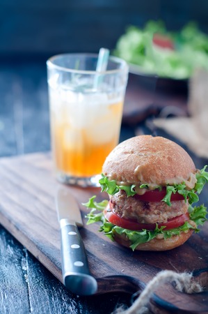 Juice homemade hamburger with fresh vegetables in tableの写真素材