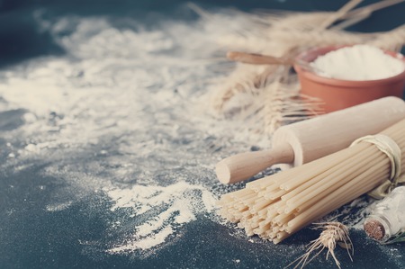 Pasta spaghetti with flour on black backgroundの写真素材