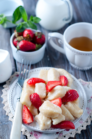 Summer dessert lazy dumplings with cottage cheese and strawberriesの写真素材