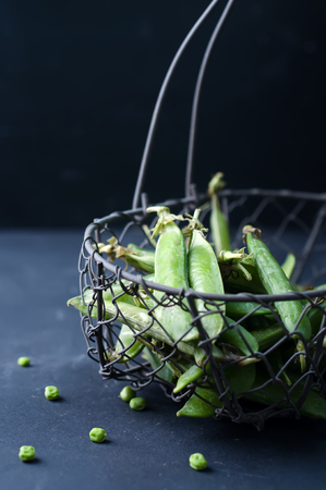 The green peas in basket on tableの写真素材