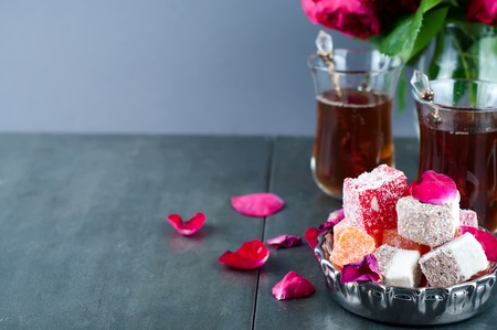 glass of Turkish tea and rahat Delight on grey backgraundの写真素材