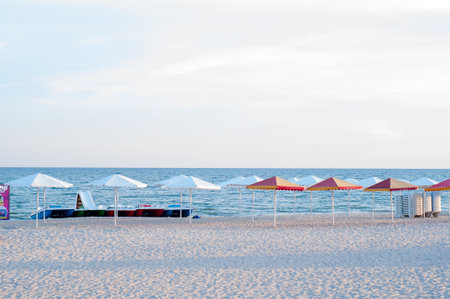 many sun umbrellas in the warm sandy beach of the tourist village