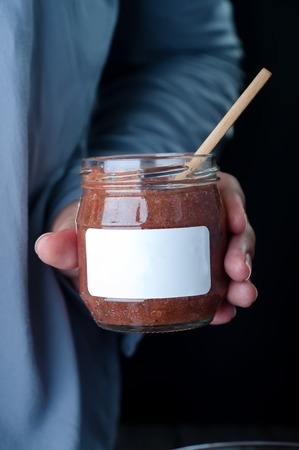 chocolate pudding dessert in a jar in his hand girlの写真素材