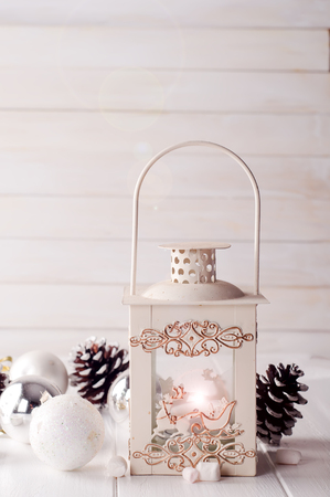 Cristmas lantern with decorations over white shabby wooden backgroundの写真素材