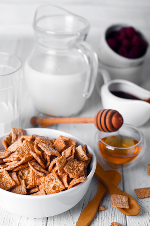 Breakfast cereal and a glass of fresh milk on white wood backgroundの写真素材