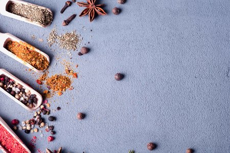 Aromatic spices on wooden spoons on a concrete background . Food ingradients.の写真素材