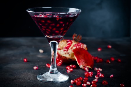 Delicious pomegranate cocktail on the black backgroundの写真素材