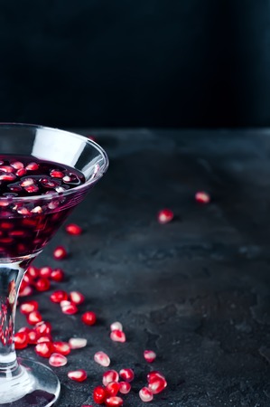 pomegranate cocktail and ripe red pomegranate fruit on the dark backgroundの写真素材