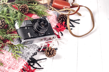 Objects top view lifestyle essentials of artist. Retro vintage film camera and a blanket. Christmas styleの写真素材