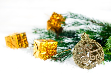 yellow christmas balls with tree on a snow backgroundの写真素材