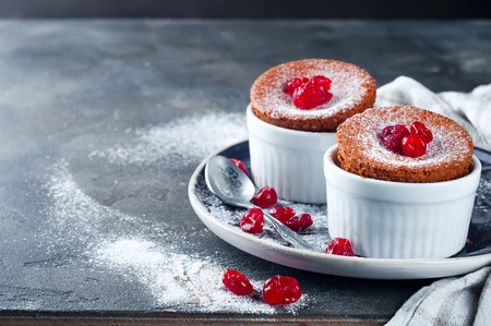 Homemade delicious souffle with dried cherries on the concrete a dark backgroundの写真素材