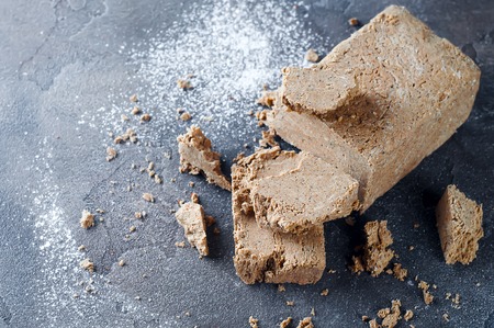 delicious pieces of halva on a dark concrete backgroundの写真素材