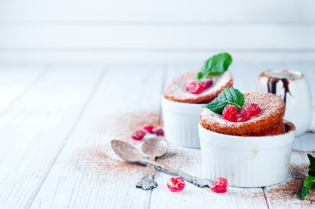 Homemade delicious souffle with dried cherries and mint on a white wooden backgroundの写真素材