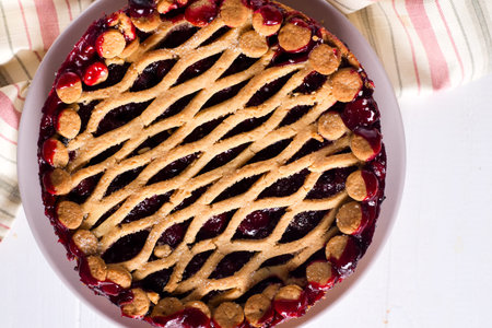 Homemade cherry pie on white wooden background