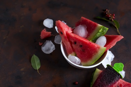 Triangle shaped watermelon slices placed with iceの写真素材