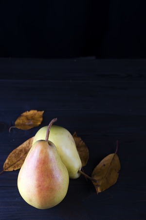 Autumn leaves and two yellow pearsの写真素材