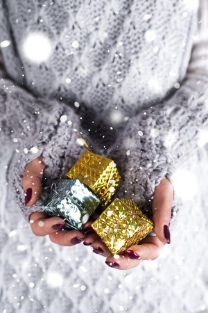 Womans hands hold christmas gift box.の写真素材